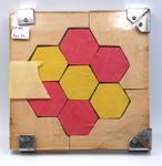 Red and Yellow Wooden Hexagonal Puzzle by Fleet Library